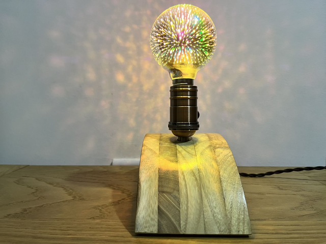 Decorative lamp made of Paulownia wood with a 3D light bulb.