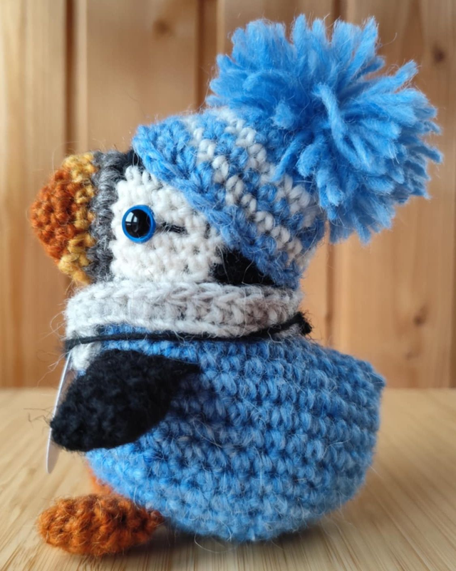 Skye the puffin wearing heaven blue sweater, scarve and hat (made from Icelandic wool yarn)