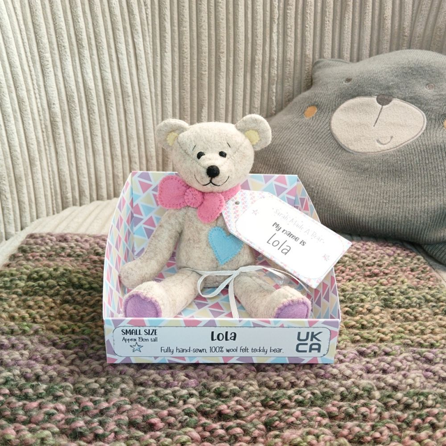 Lola. Small size, handmade teddy bear. UKCA. Tray base packaging. Standard Wool Felt. Beige. Rainbow. Yellow. Purple. Blue. Pink.