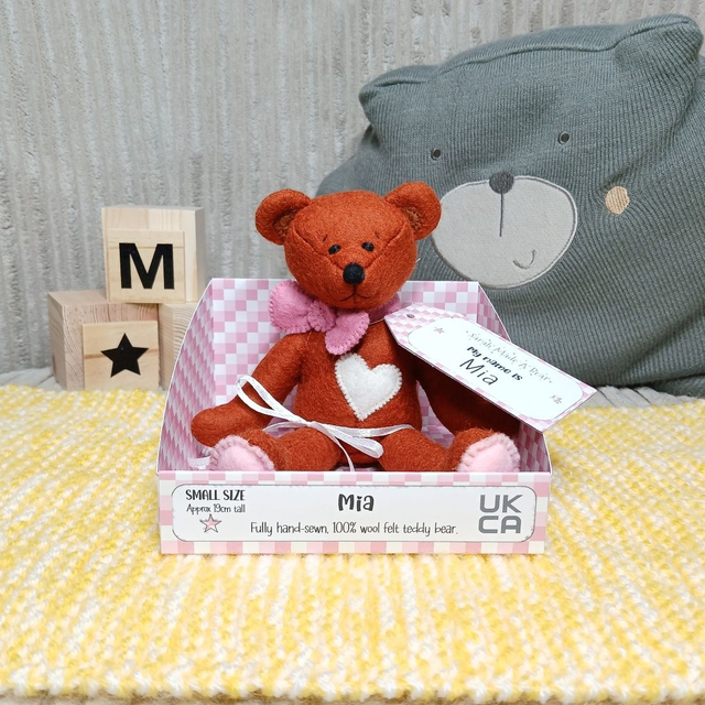 Mia. Small size, handmade teddy bear. UKCA. Tray base packaging. Standard Wool Felt. Reddish-Brown. Pink. Cream. 