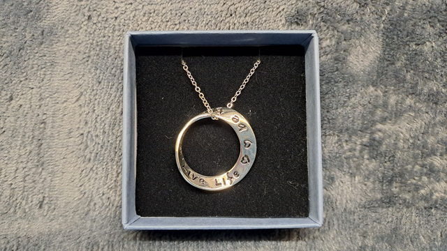 Silver Coloured Twisted Ring Necklace Inscribed.