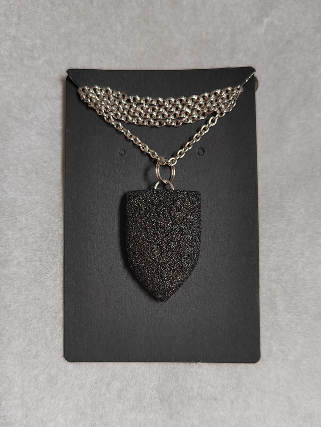 Black textured pendant with chain and leather cord