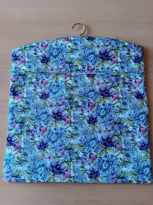 Hand made Peg Bag with wooden coat hanger. Floral print fabric with plain lining.