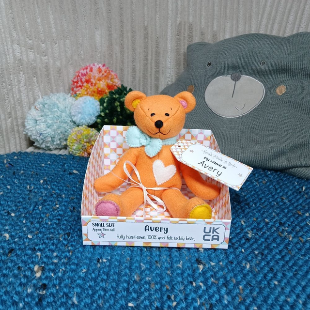 Avery. Small size, handmade teddy bear. UKCA. Tray base packaging. Standard Wool Felt. Orange. Yellow. Pink. Spearmint blue. White.