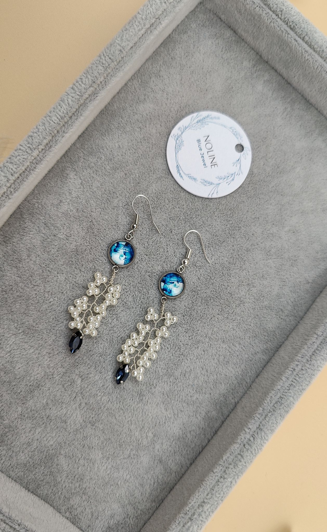Boucles d’oreilles pendantes argentées avec cabochon abstrait bleu, perles blanche et strass bleue foncé