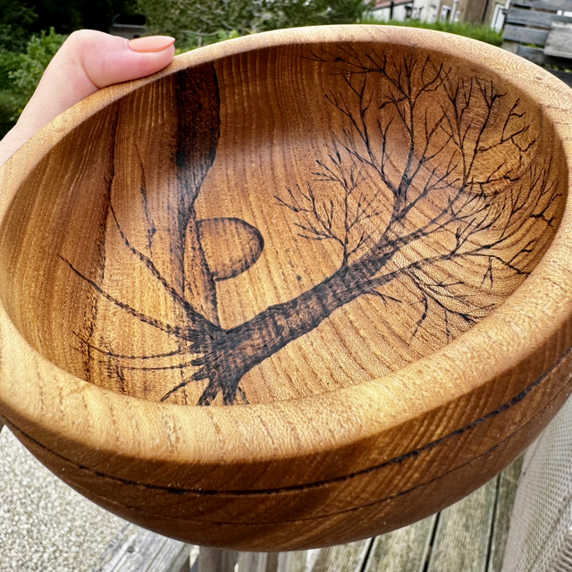 Hardwood wooden bowl featuring a pyrography nature inspired scene 