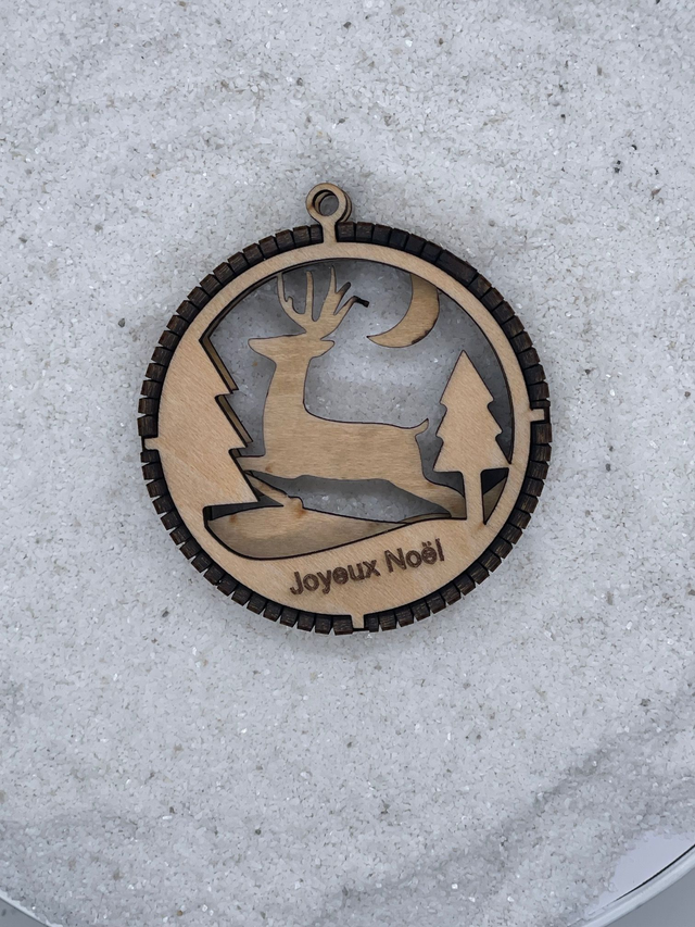 Boule de Noël en bois motif Renne dans la forêt.