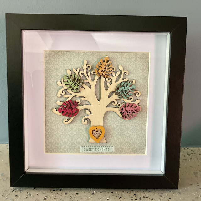 Wooden tree frame with colourful wooden leaves. Sweet moments quote.