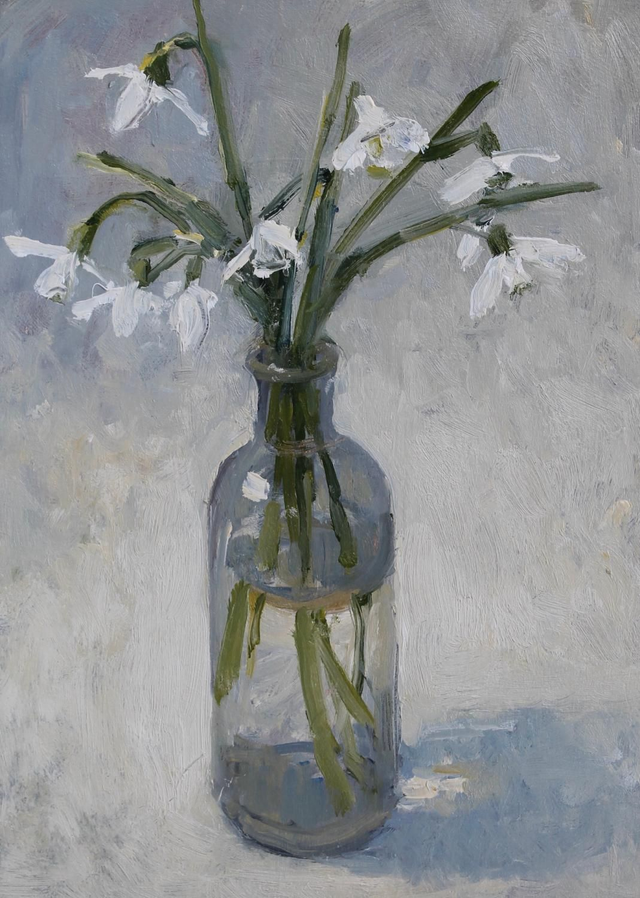 Snow drops in a glass bottle