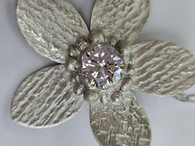 Flower in fine silver with large white cubic zirconia setting