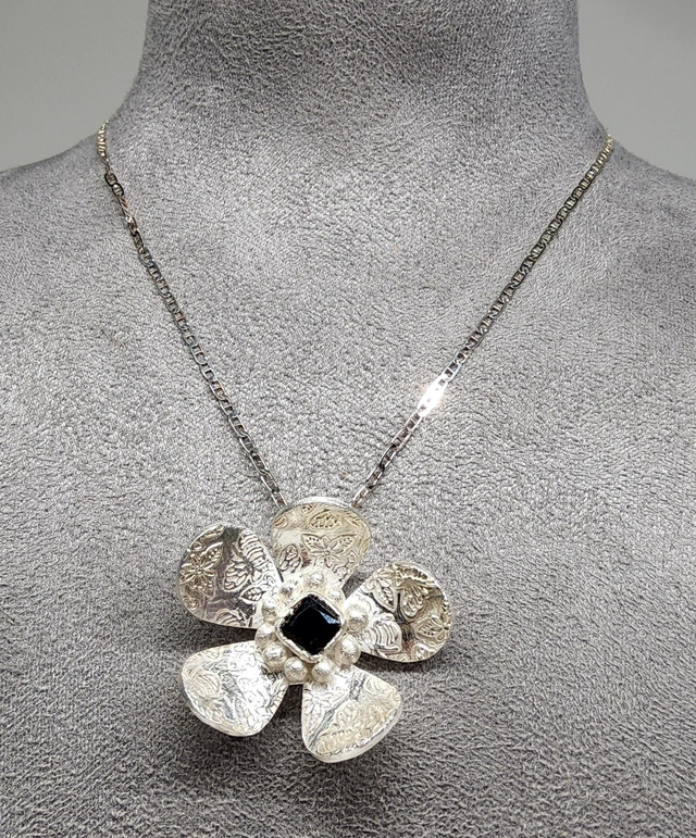 Bee print flower pendant with dark emerald cubic zirconia on silver necklace