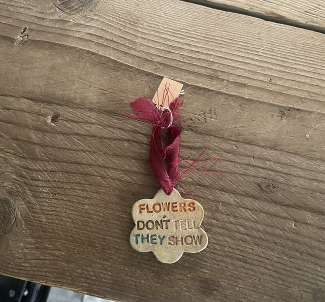 Small Clay ‘flowers don’t tell they show’ sign