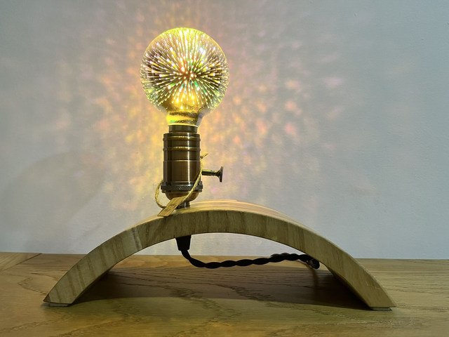 Stylish decorative lamp made of Paulownia wood with a 3D light bulb.