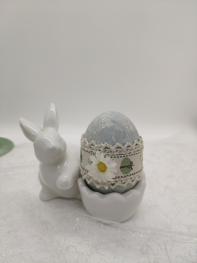 White ceramic bunny holding a duck egg 