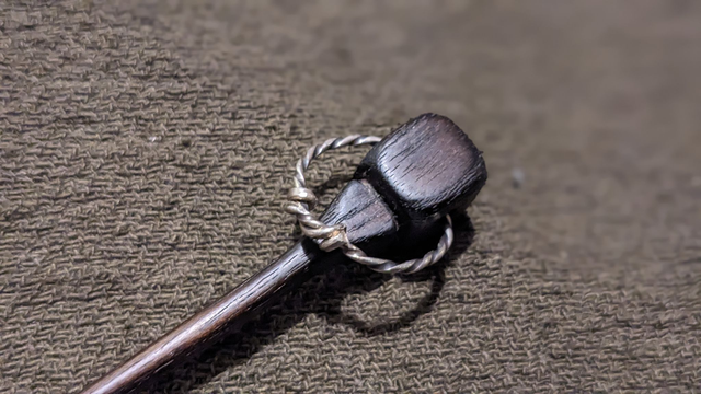 Black hardwood polyhedral pin with silver ring