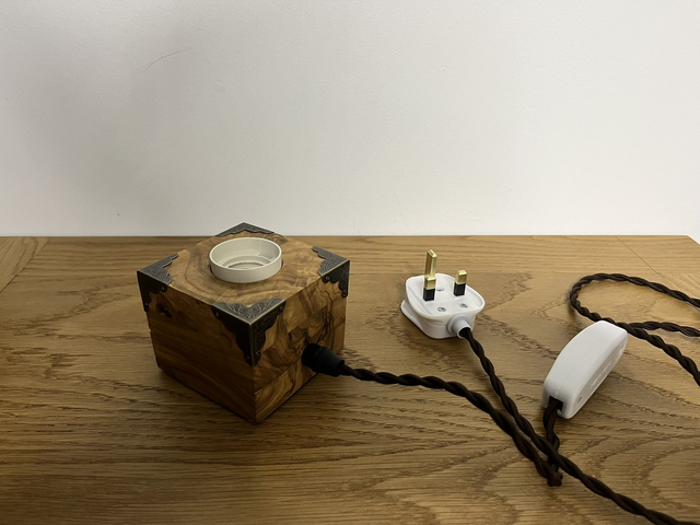 Rustic bedside lamp made of olive wood.