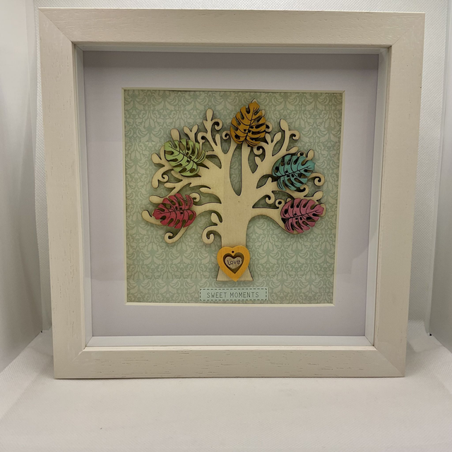 Wooden tree frame with colourful wooden leaves. Sweet moments quote.