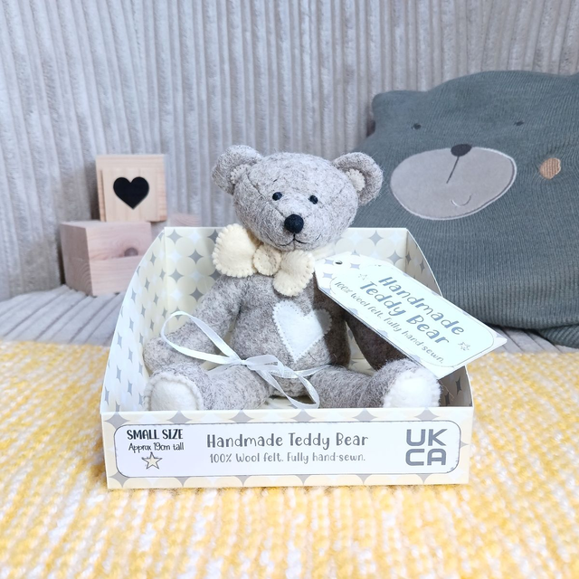 Brown/grey with pastel yellow, white and cream. *No name* . Small size, handmade teddy bear. UKCA. Tray base packaging. Limited Edition Wool Felt. 