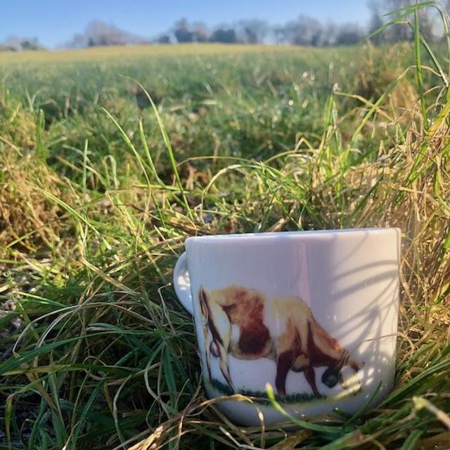 Cow grazing in front of the Peak District upcycled mug