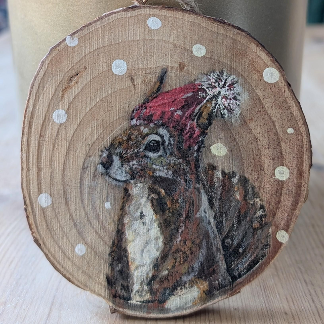 Squirrel in wooly hat, snow - Log slice