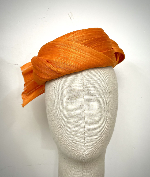 Orange abaca pillbox with twisted knot trim at back