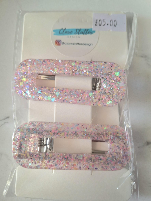 Pink and peach glitter click clack clip pair