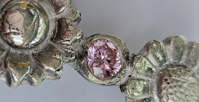 Two flower fine silver pendant with a pink cubic zirconia 