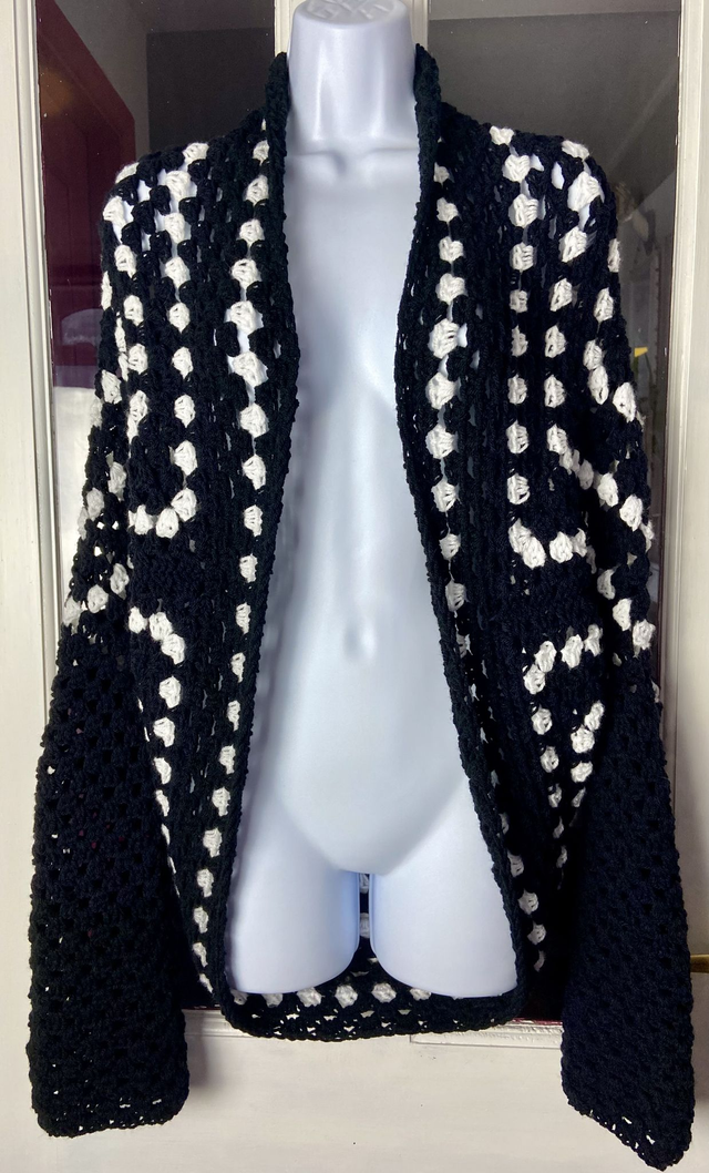 Black and white shrug style cardigan.