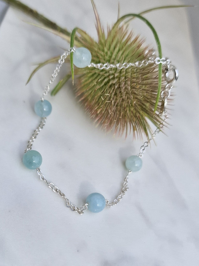 Natural beautiful Aquamarine 6mm stones with an infinity link 925 silver chain. medium size but can be enlarged.