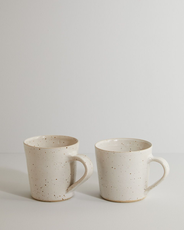 A pair of white speckle mugs