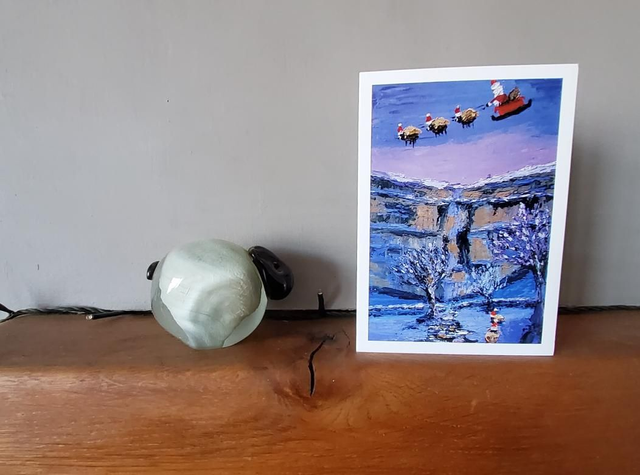 Father Christmas and his flying sheep over Malham Cove. A6 Christmas card. 