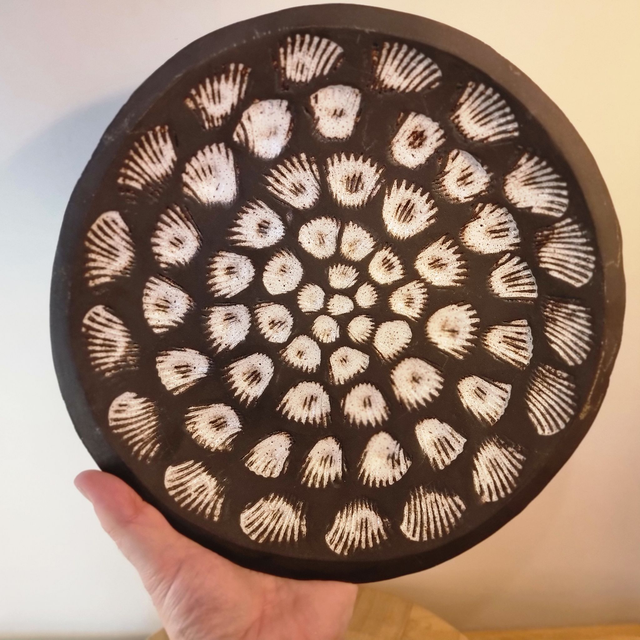 Black clay stoneware bowl with seashell impressions 