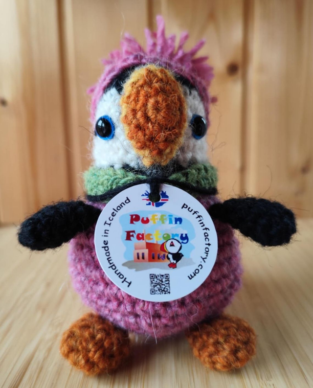 Pixie the puffin wearing pink heather sweater, scarve and hat (made from Icelandic wool yarn)