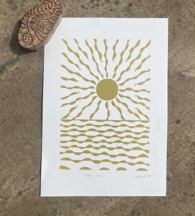 The Sun, Lino print in mustard yellow.