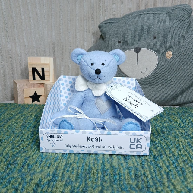 Noah. Small size, handmade teddy bear. UKCA. Tray base packaging. Standard Wool Felt. Blue. White. Grey.