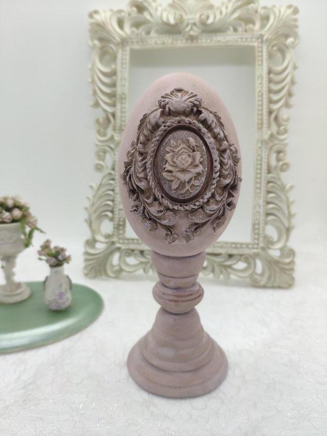 Pink Goose egg on a wooden painted stand