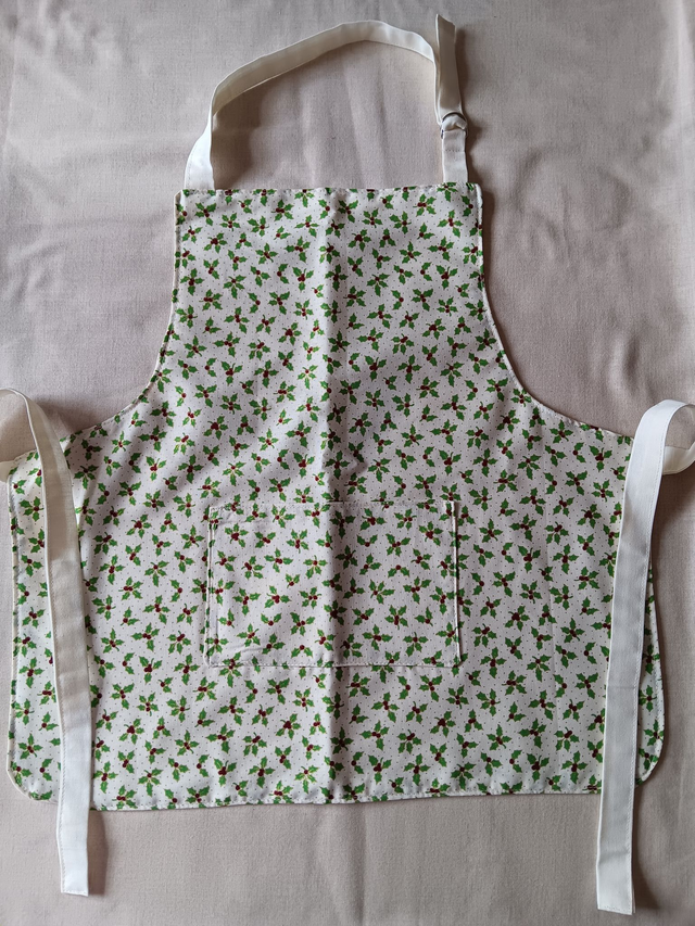 Childs Kitchen Play Apron Cream Holly &amp; Berries Patterned Cotton Fabric with Front pocket and Cream lining, waist ties and adjustable neck ties 