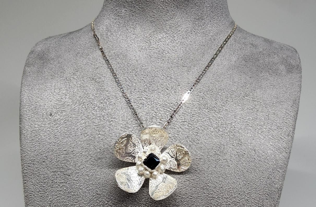 Bee print flower pendant with dark emerald cubic zirconia on silver necklace