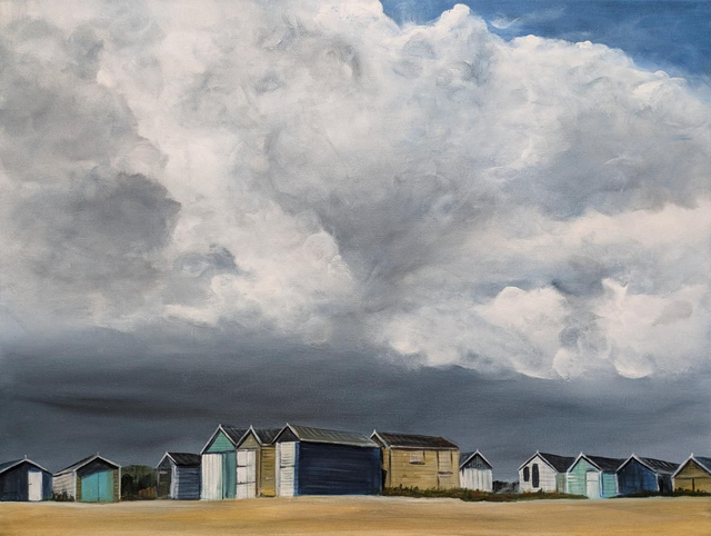 Storm clouds over Hayling Island beach huts
