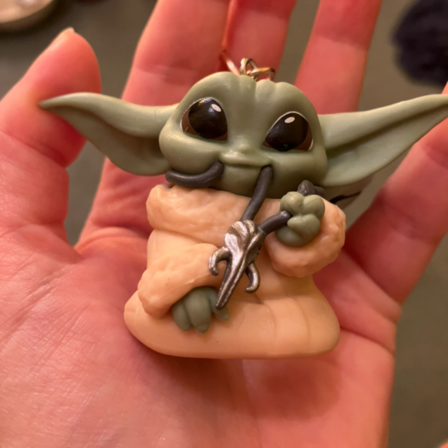 Baby Grogu eating his necklace