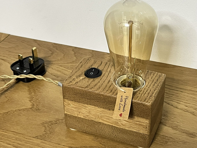 Rustic bedside lamp made of oak wood with a switch and an Edison bulb.