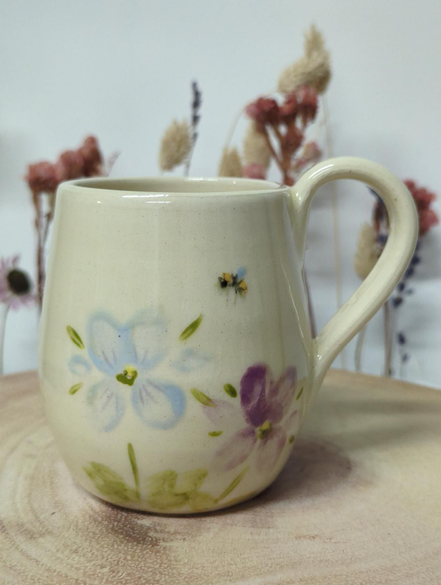 Hand thrown ceramic coffee mug with hand painted floral design