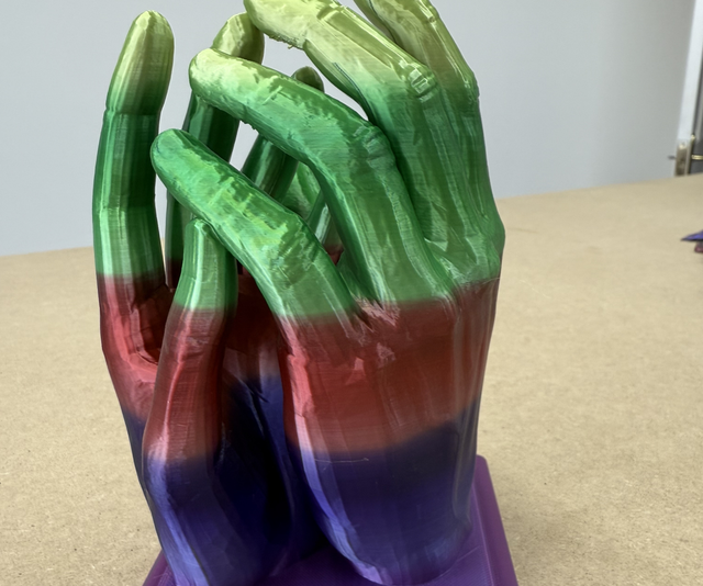 3D printed entwined hands in multi colour