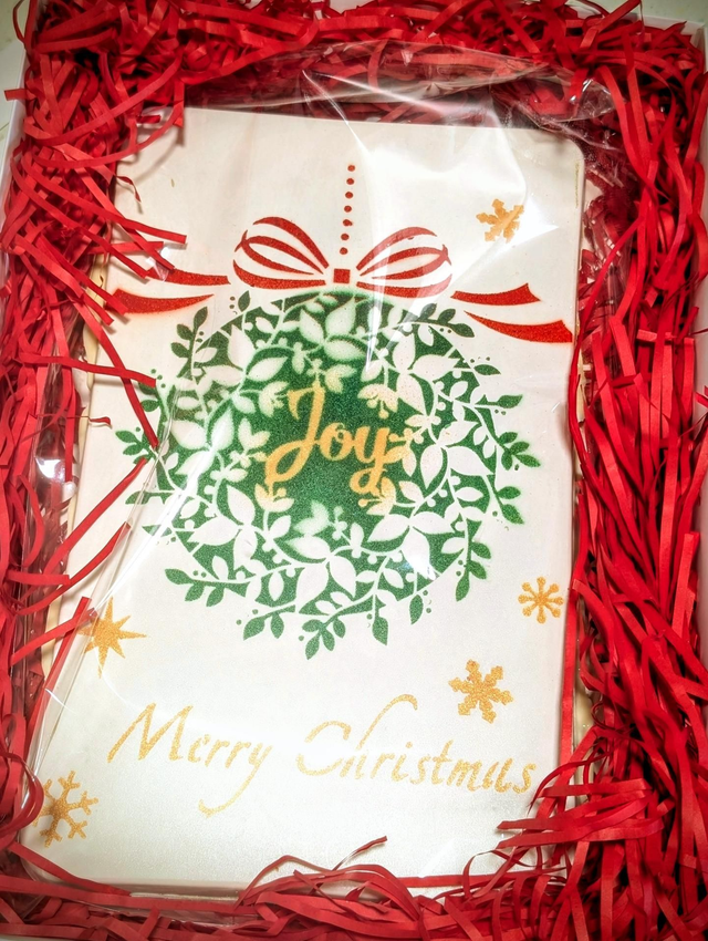 Giant, white chocolate, 750g bar filled with pistachio cream and feuillietine then topped with chopped pistachios.