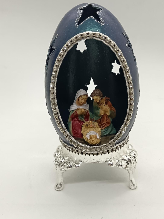 Blue Goose egg with star's cut out on a silver stand