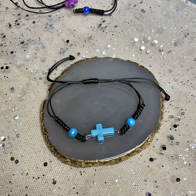 Adjustable bracelet with quartz cross. Fully adjustable cord bracelet.