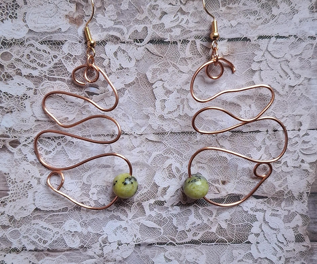 A lovers journey in bronze with serpentine, two earrings