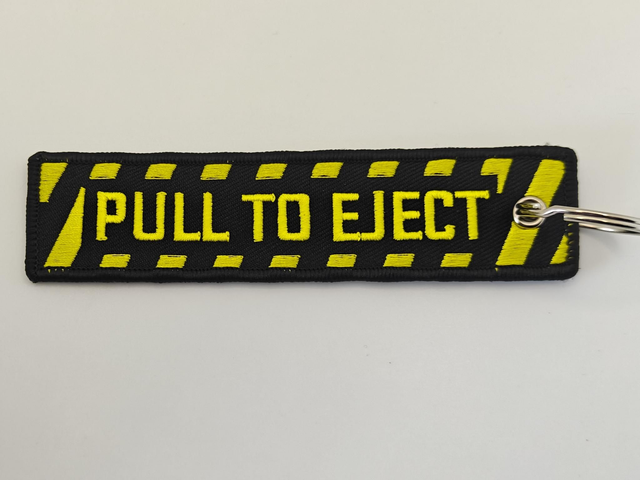 Pull to eject key chain 