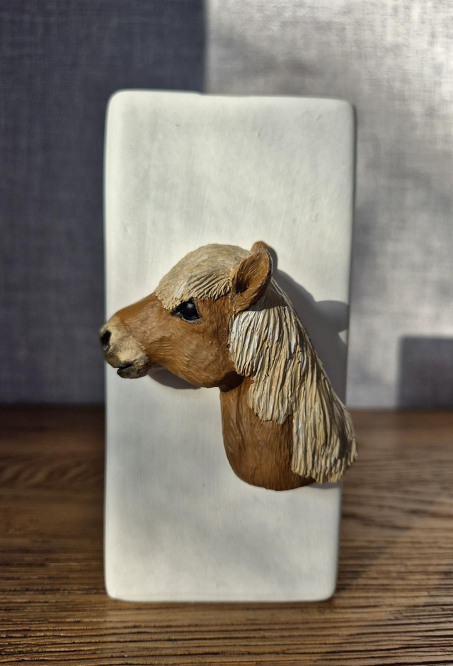 Horse head on ceramic vase