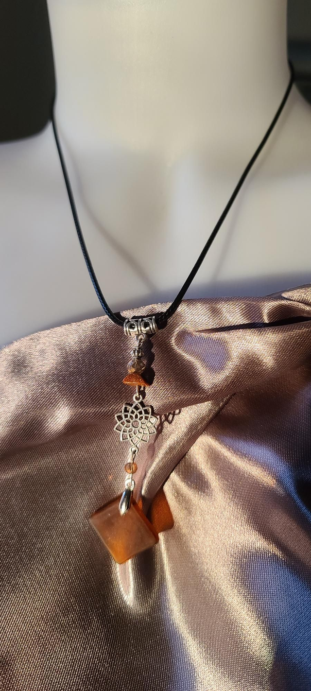 Pendentif en verre caramel dépoli et cordon en coton ciré noir.